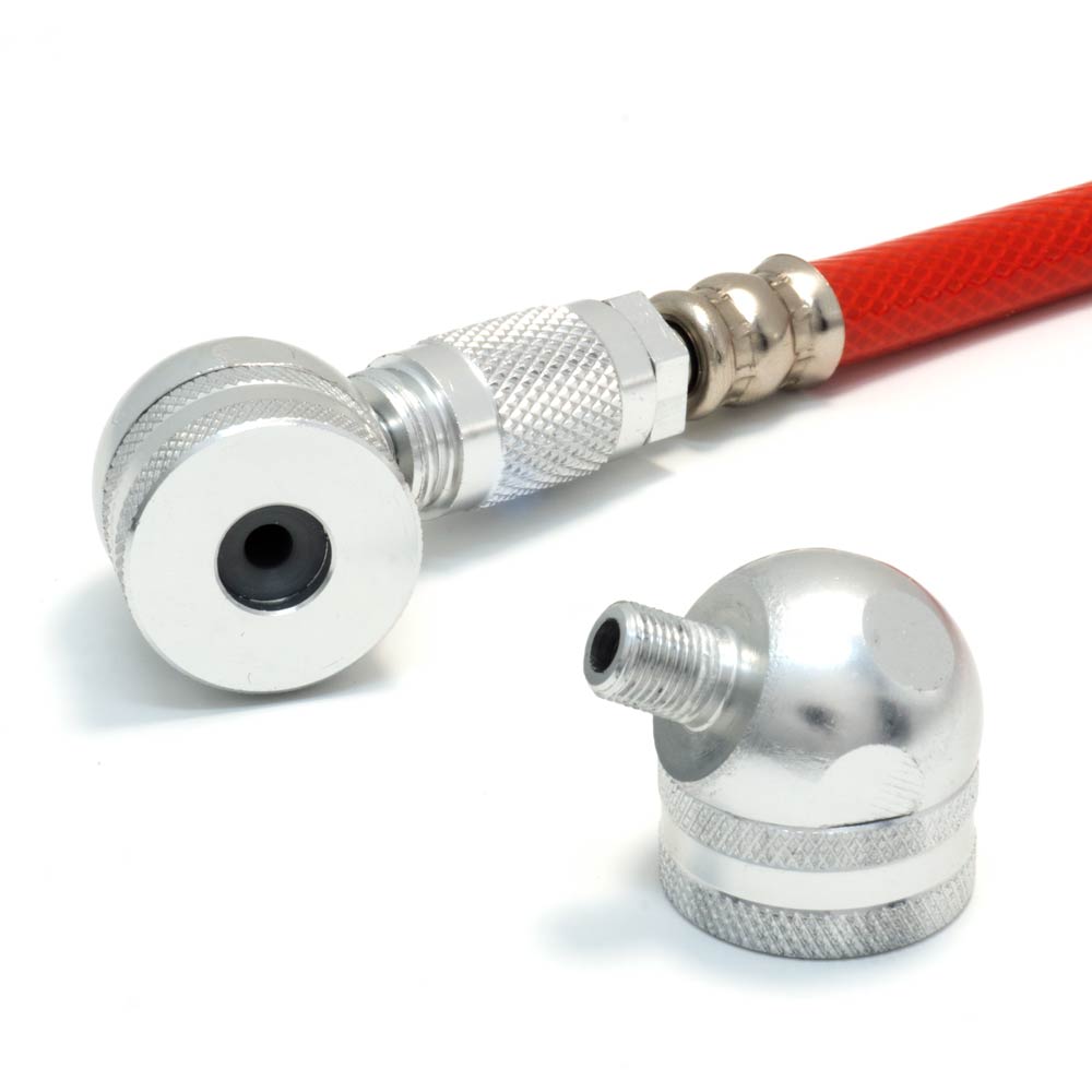 Close-up of Prestacycle’s Prestaflator Digital Bicycle Tire Inflator for Presta & Schrader valves, showing its red flexible hose with a silver connector and a separate silver fitting on a white surface.