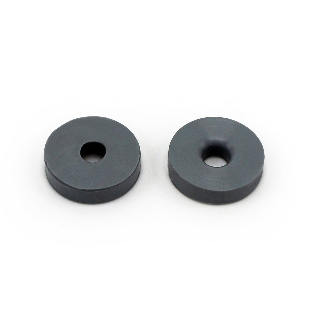 Two round, flat, dark gray Prestacycle Prestaflator Mini Presta Head Gasket washers with central holes are shown side by side on a white background.