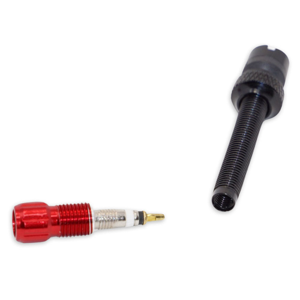 A Prestacycle Prestadapter TUBELESS Presta adapter and valve core remover, along with a metal valve core featuring a red cap, are shown on a white background.