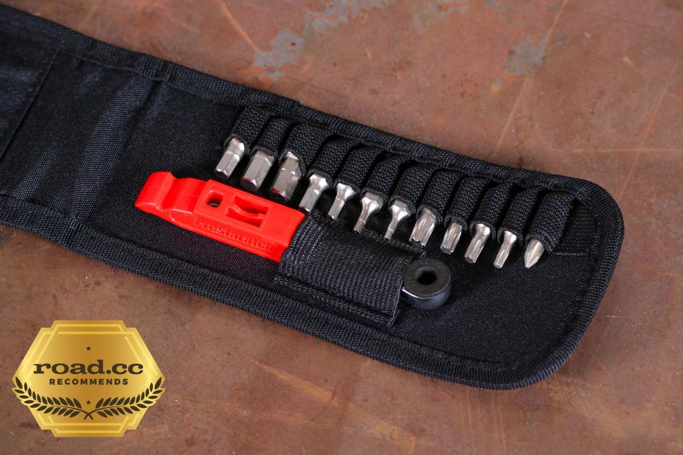 The Prestacycle Prestaratchet GO Multi-tool Wallet Kit—shown open with its black fabric case—displays metal screwdriver bits, a red tire lever, and a bicycle ratchet tool; a gold road.cc recommends badge appears in the lower left corner.