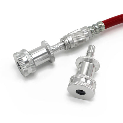 Prestacycle EZ-Grip Big Presta Heads by Prestacycle, featuring knurled grips and a cylindrical design, are shown on a white background—one attached to a red hose, the other detached—ideal for tubeless tire Presta valve setups.