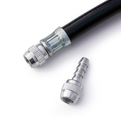 A close-up of a Prestacycle Schrader Hose Barb, featuring a black hose with a metal connector attached and an additional metal connector beside it, displayed on a white background.