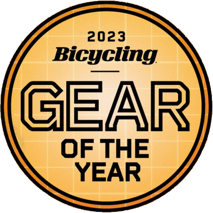 A round orange badge with a grid pattern, displaying 2023 Bicycling Gear of the Year in bold black and white—perfect for highlighting the Prestacycle UniBlock PRO Cassette (12 Speed) by Prestacycle, Shimano HG12 compatible.