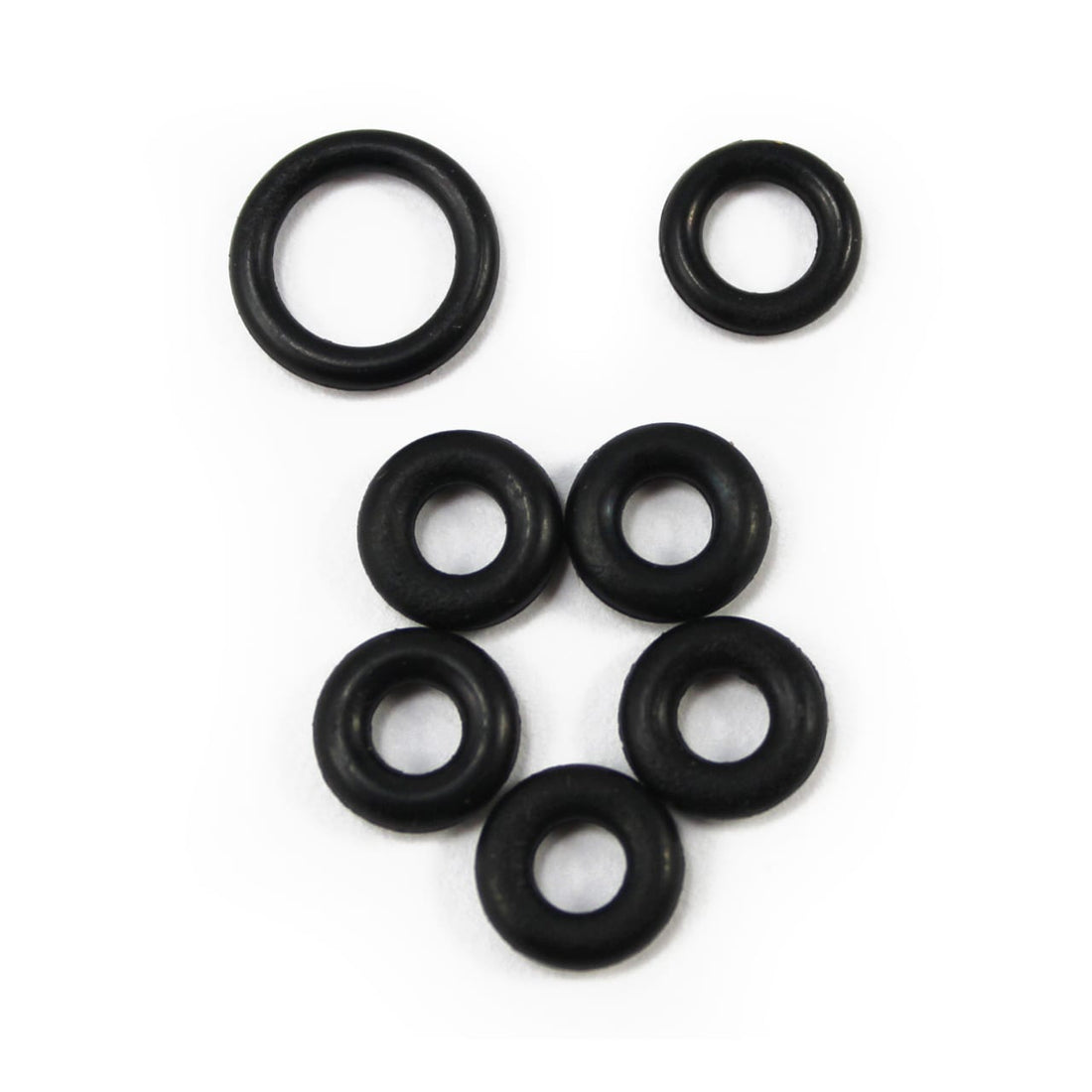 Seven black rubber O-rings from the Prestacycle Prestaflator Spin Head Rebuild Kit are arranged on a white background—two on top, five below—making them perfect as spare parts for your Prestaflator.