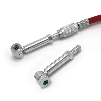 The Prestacycle Disc Wheel Mini Presta Head, by Prestacycle, is displayed on a white background with two silver metal valve stem extensions—one attached to a red hose and one detached—alongside a Presta valve adapter.