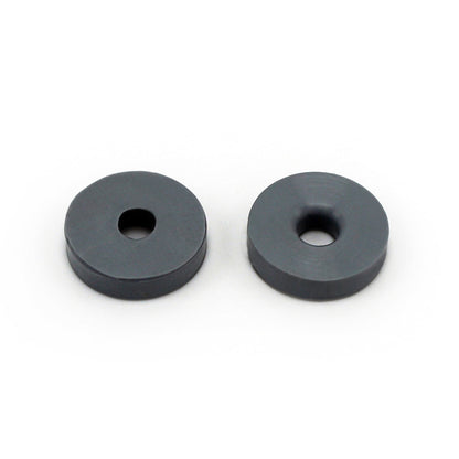 Two round, flat, dark gray Prestacycle Prestaflator Mini Presta Head Gasket washers with central holes are shown side by side on a white background.