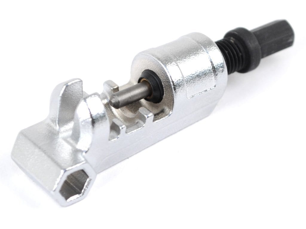 A close-up of the Prestacycle PrestaRatchet Chain Accessory, a compact chain breaker with a black handle for removing and installing bike chain pins. This portable tool features a threaded spindle and a slot to hold the chain in place.