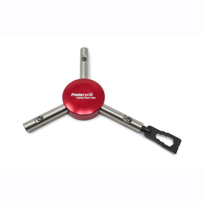 The Prestacycle Mini Pry Bar Specialty Bit, part of the Prestacycle accessory line, features a red circular center, three metal arms including a black adapter, and offers portable functionality. Displayed on a white background.