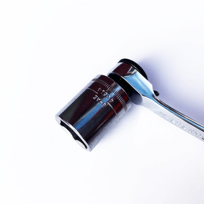 A close-up of the Prestacycle Professional Low-Profile 1/4 Hex to 1/4 Square Socket Adapter by Prestacycle, made from hardened S2 steel for durability, positioned diagonally on a white background.