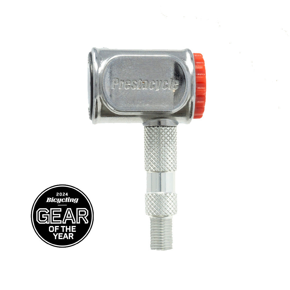 The Prestacycle Pro Presta Head bicycle pump, silver with a red knob and engraved branding, featuring a no-loss disconnect, is pictured beside a 2024 Bicycling Gear of the Year award badge.