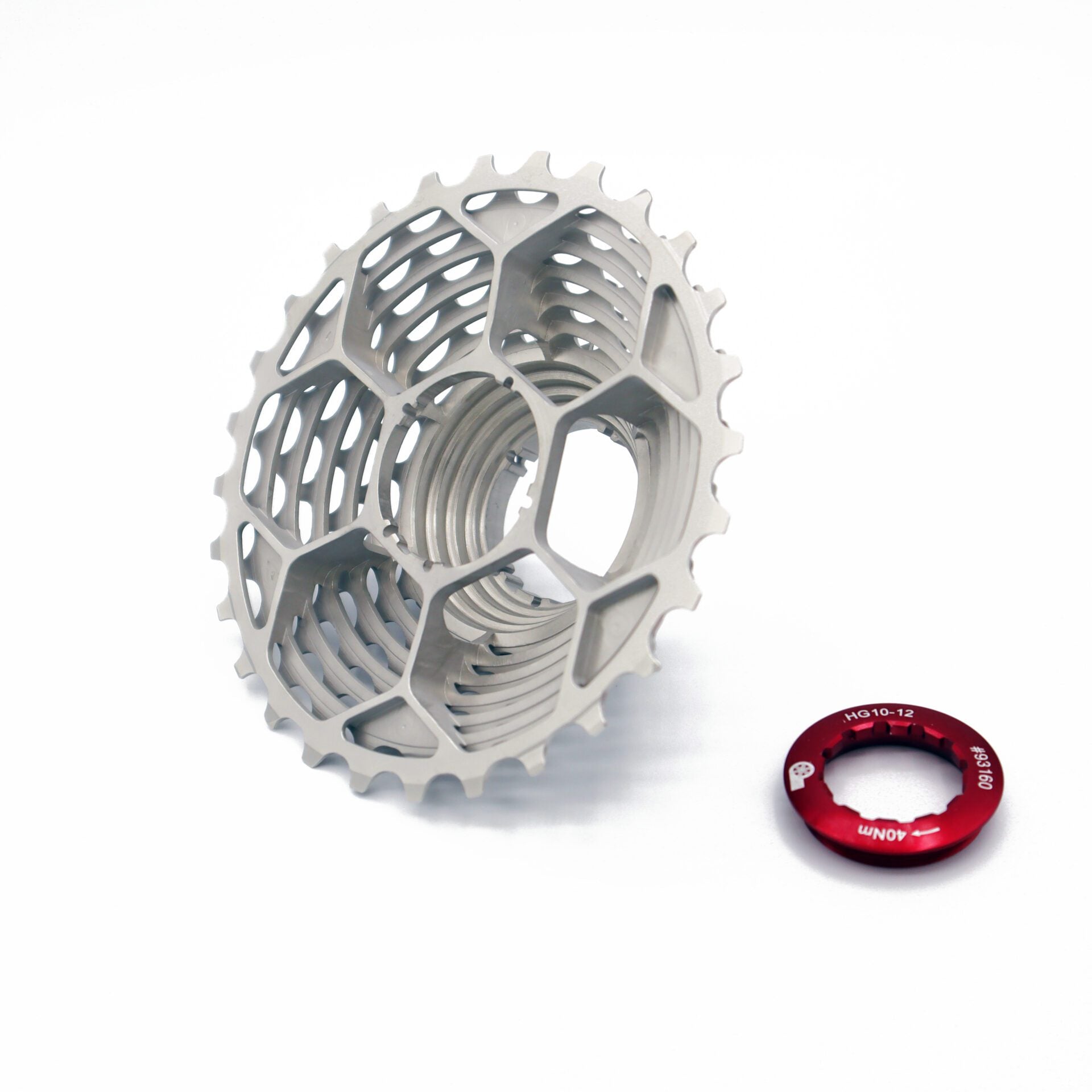The Prestacycle UniBlock PRO 12 speed cassette by Prestacycle, made from tough ChroMoly steel with a honeycomb design, is shown beside a small red component. It’s Shimano HG12 compatible for smooth shifting on a white background.