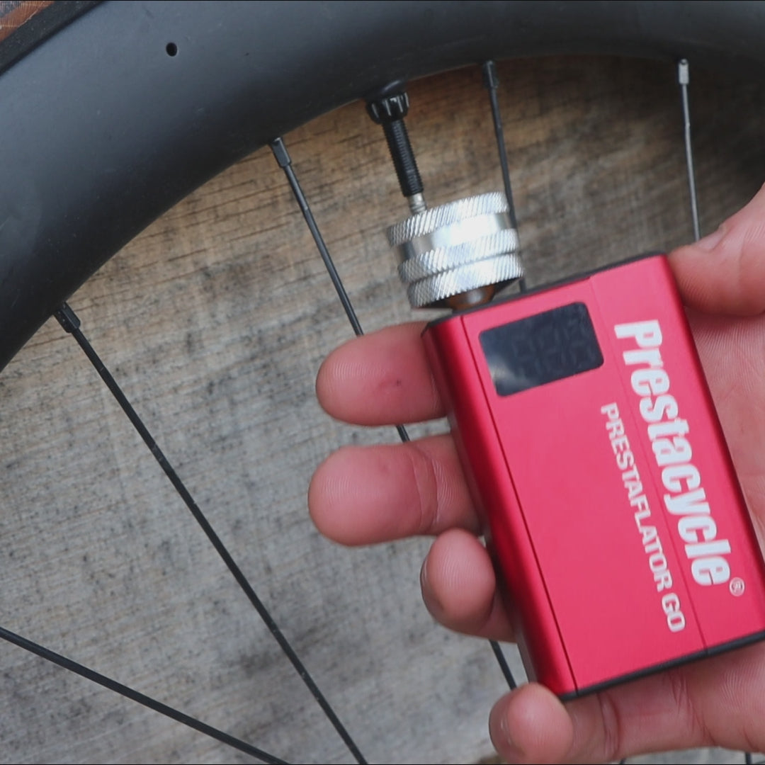 prestaflator go digital bicycle tire inflation tool in use on road bike tire 