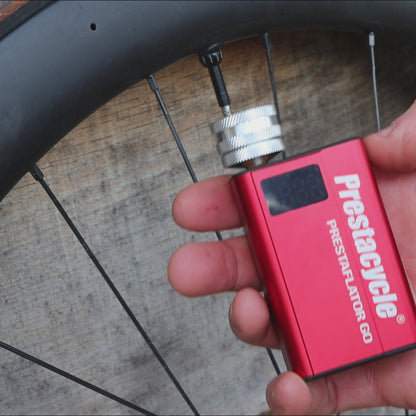 prestaflator go digital bicycle tire inflation tool in use on road bike tire 